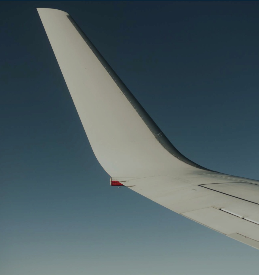 Aircraft wing against blue sky